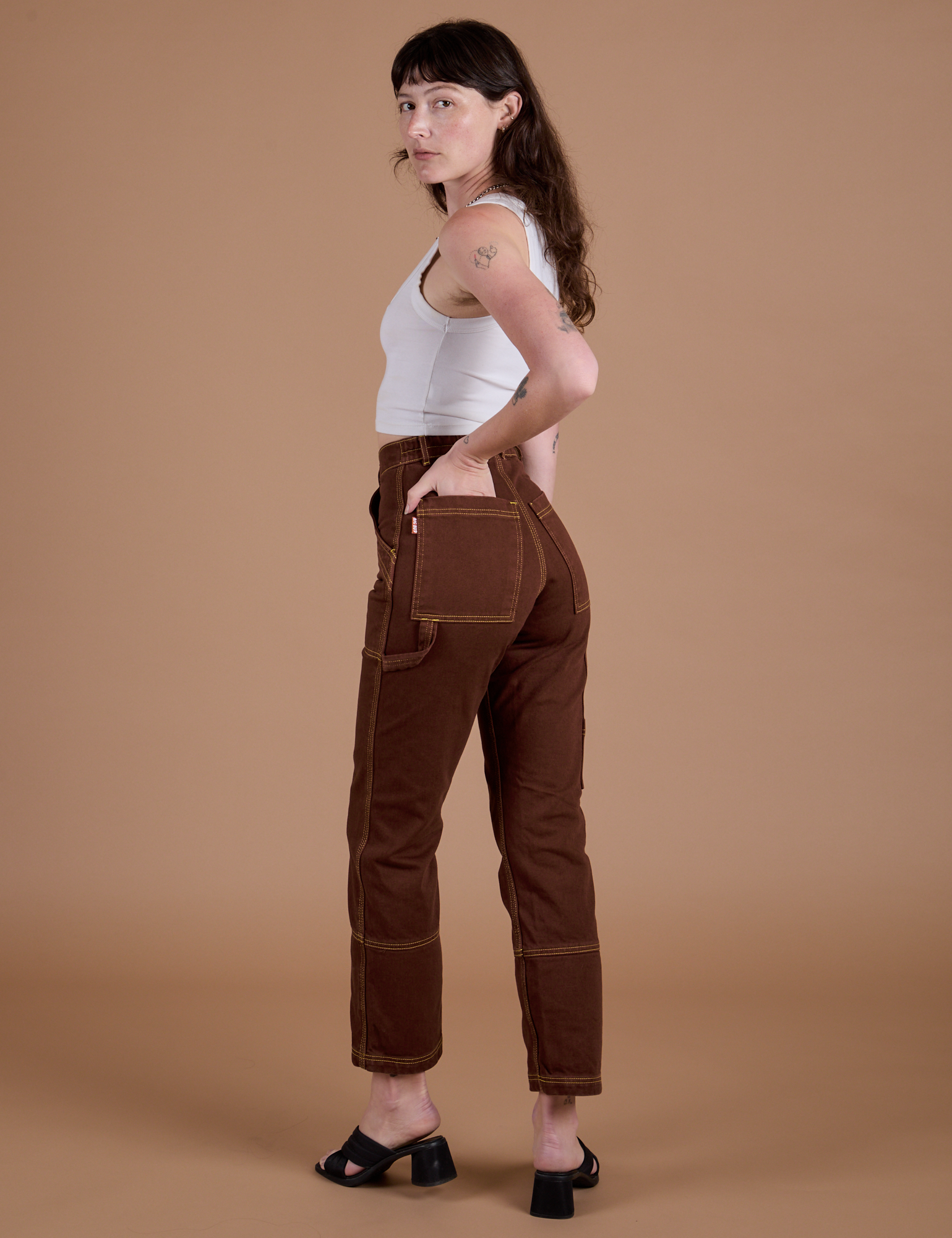 Carpenter Jeans in Fudgesicle Brown angled back view on Alex