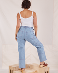 Back view of Carpenter Jeans in Light Wash and Cropped Cami in vintage tee off-white worn by Tiara