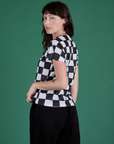 Angled back view of Checker Organic Tee in Black on Alex