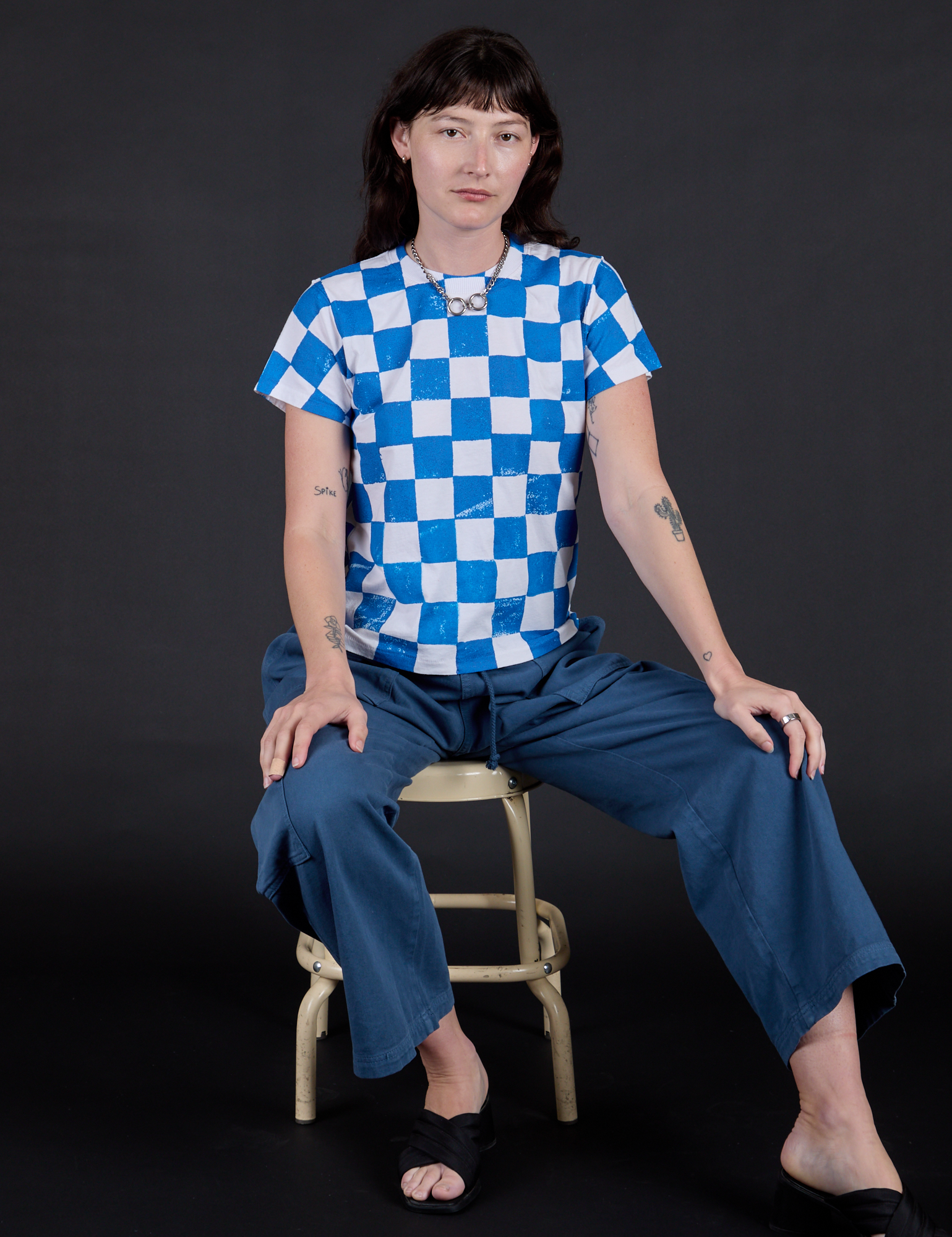 Alex is wearing Checker Organic Tee in Blue and Drop Pocket Cargo Pants in French Blue