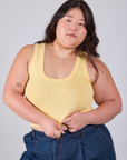 Ashley is 5'7" and wearing L Cropped Tank Top in Butter Yellow
