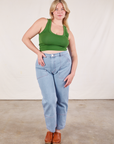 Lish is wearing Cropped Tank Top in Lawn Green and light wash Carpenter Jeans