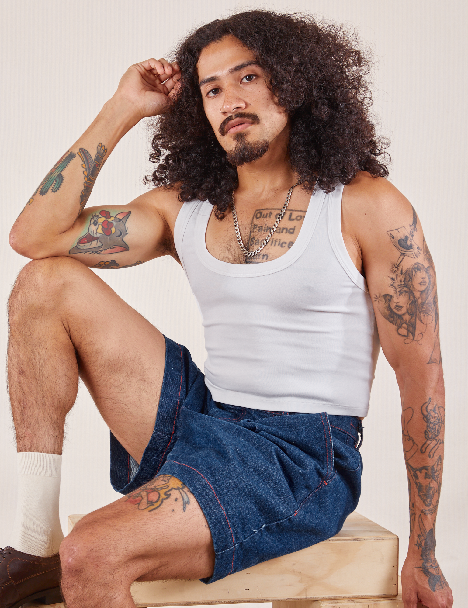 Jesse is wearing Denim Trouser Shorts in Dark Wash and Cropped Tank in vintage tee off-white