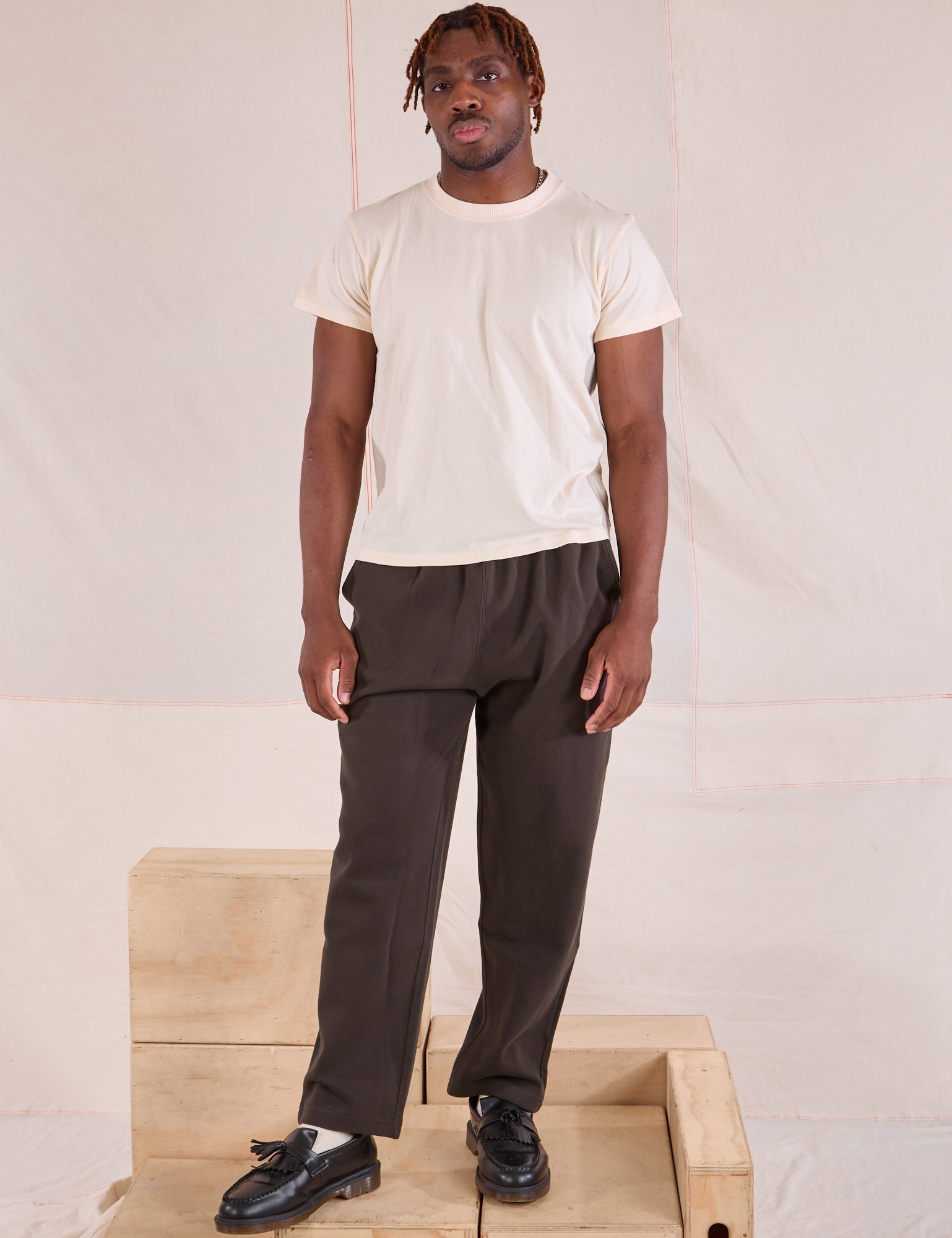 Issac is 5&#39;10&quot; and wearing M Easy Pants in Espresso Brown paired with Organic Vintage Tee in vintage tee off-white