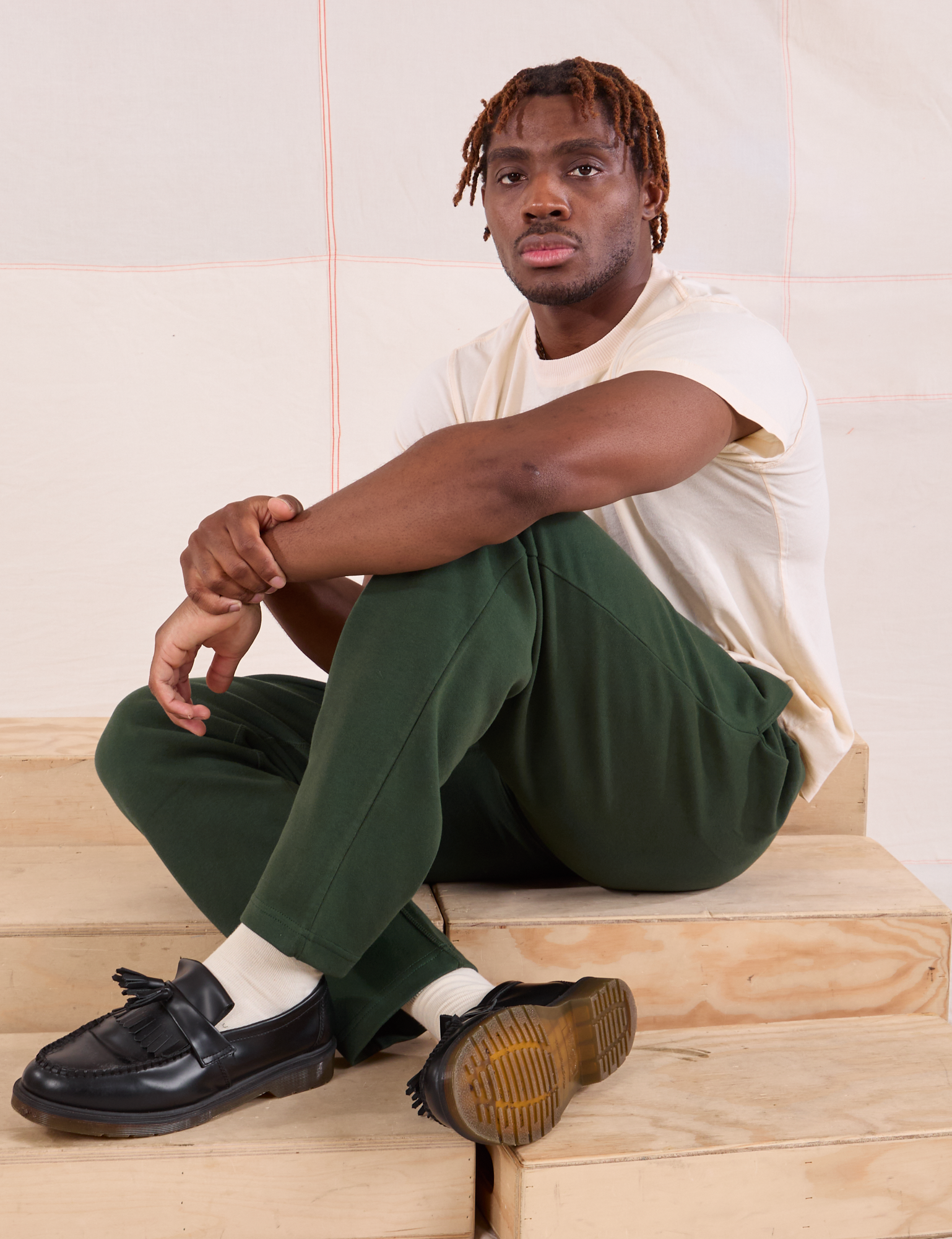 Issac is wearing Easy Pants in Swamp Green and Organic Vintage Tee in Vintage Tee Off-White