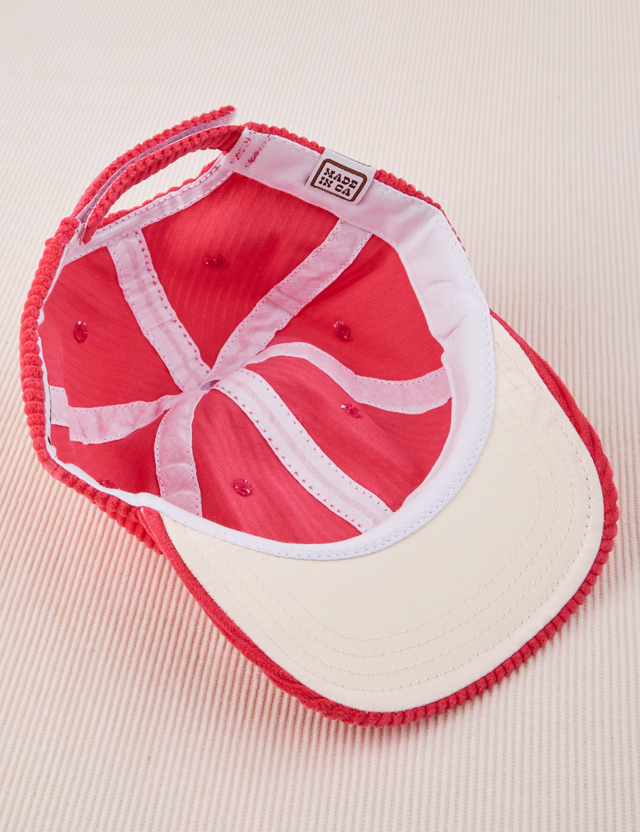 Dugout Corduroy Hat in Hot Pink flipped over. White satin under-bill.