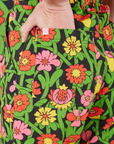Flower Tangle Jumpsuit back pocket close up. Alex has her hand in the pocket.