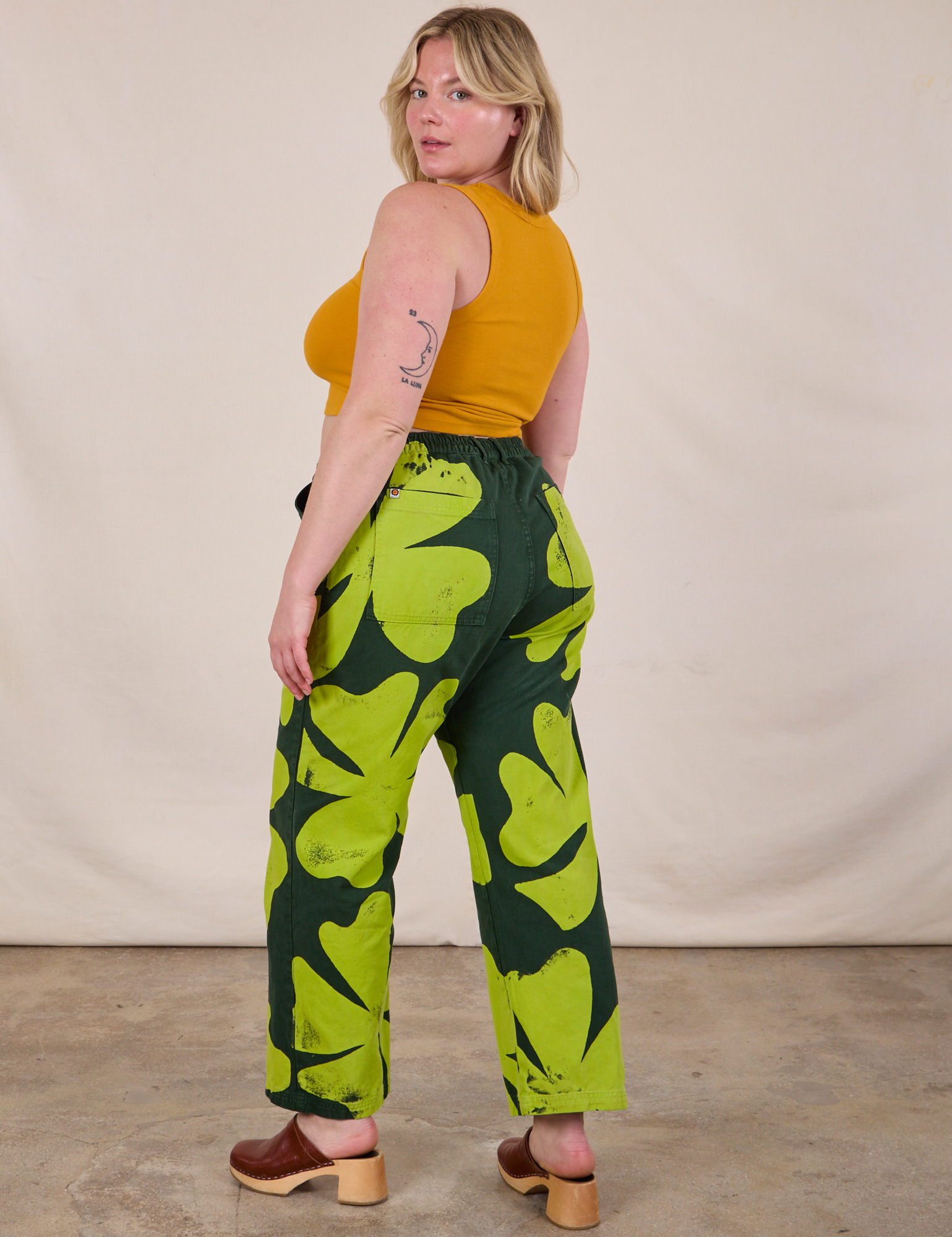 Angled back view of Paintstamped Clover Work Pant and Mustard Yellow Cropped Tank on Lish