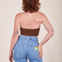Back view of Halter Top in Fudgesicle Brown and light wash Frontier Jeans worn by Alex