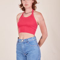 Alex is 5'8" and wearing P Halter Top in Hot Pink paired with light wash Frontier Jeans