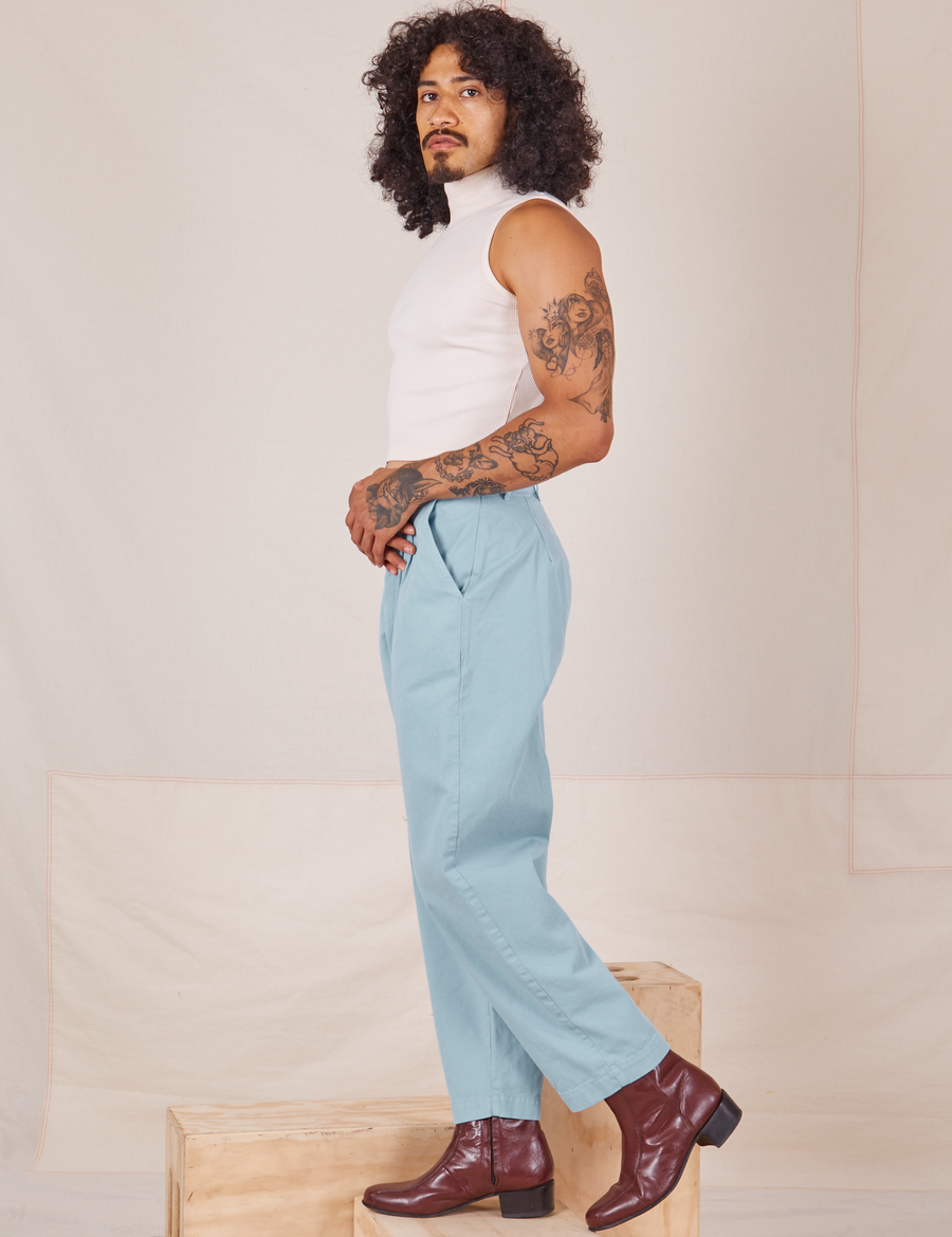 Side view of Heavyweight Trousers in Baby Blue and vintage off-white Sleeveless Turtleneck worn by Jesse