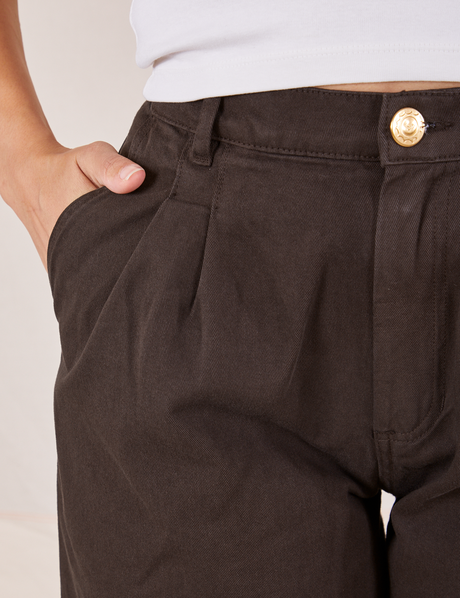 Front close up of Heavyweight Trousers in Espresso Brown. Tiara has her hand in the pocket.