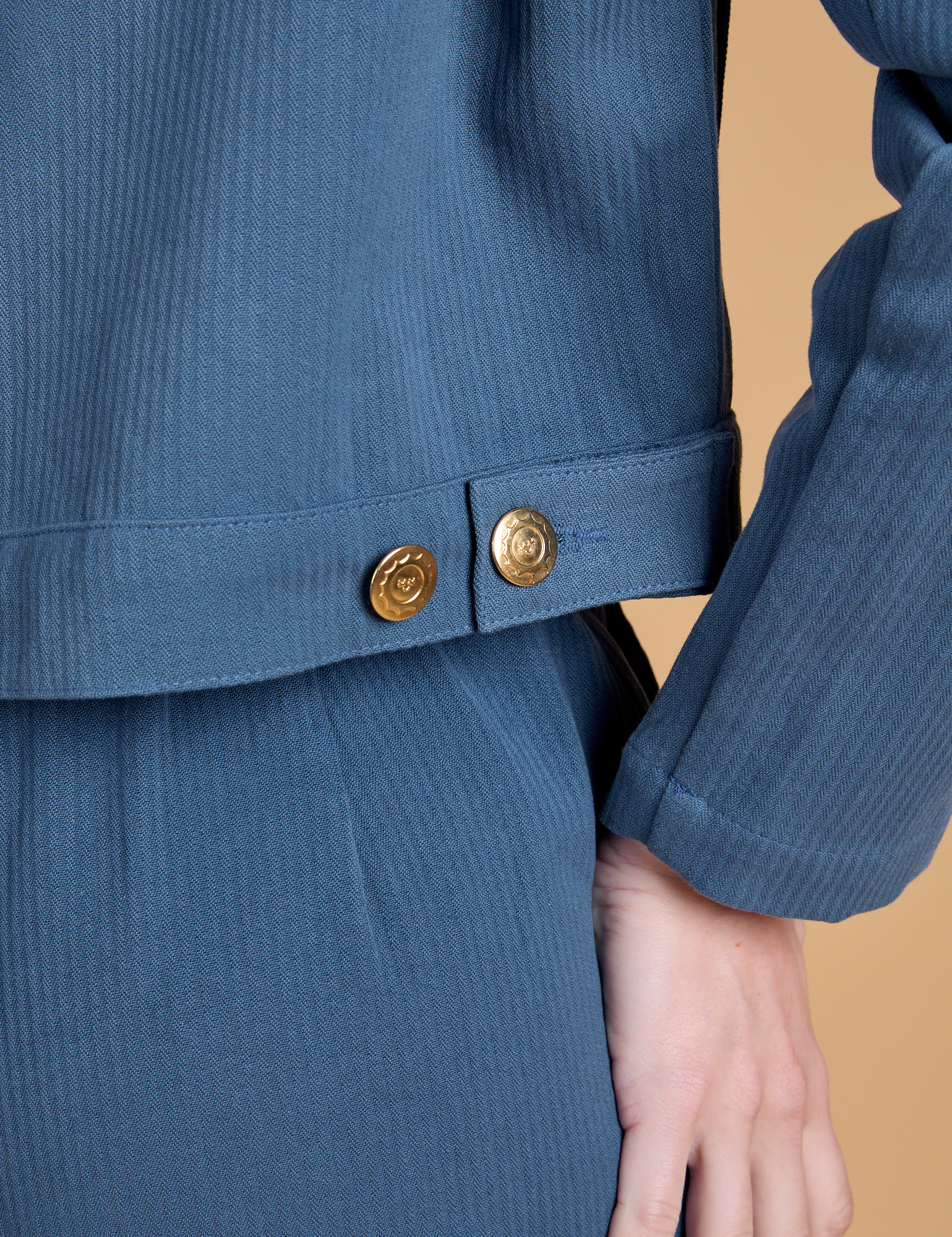 Close up of side brass snaps on Heritage Mechanic Jacket in French Blue