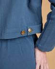 Close up of side brass snaps on Heritage Mechanic Jacket in French Blue