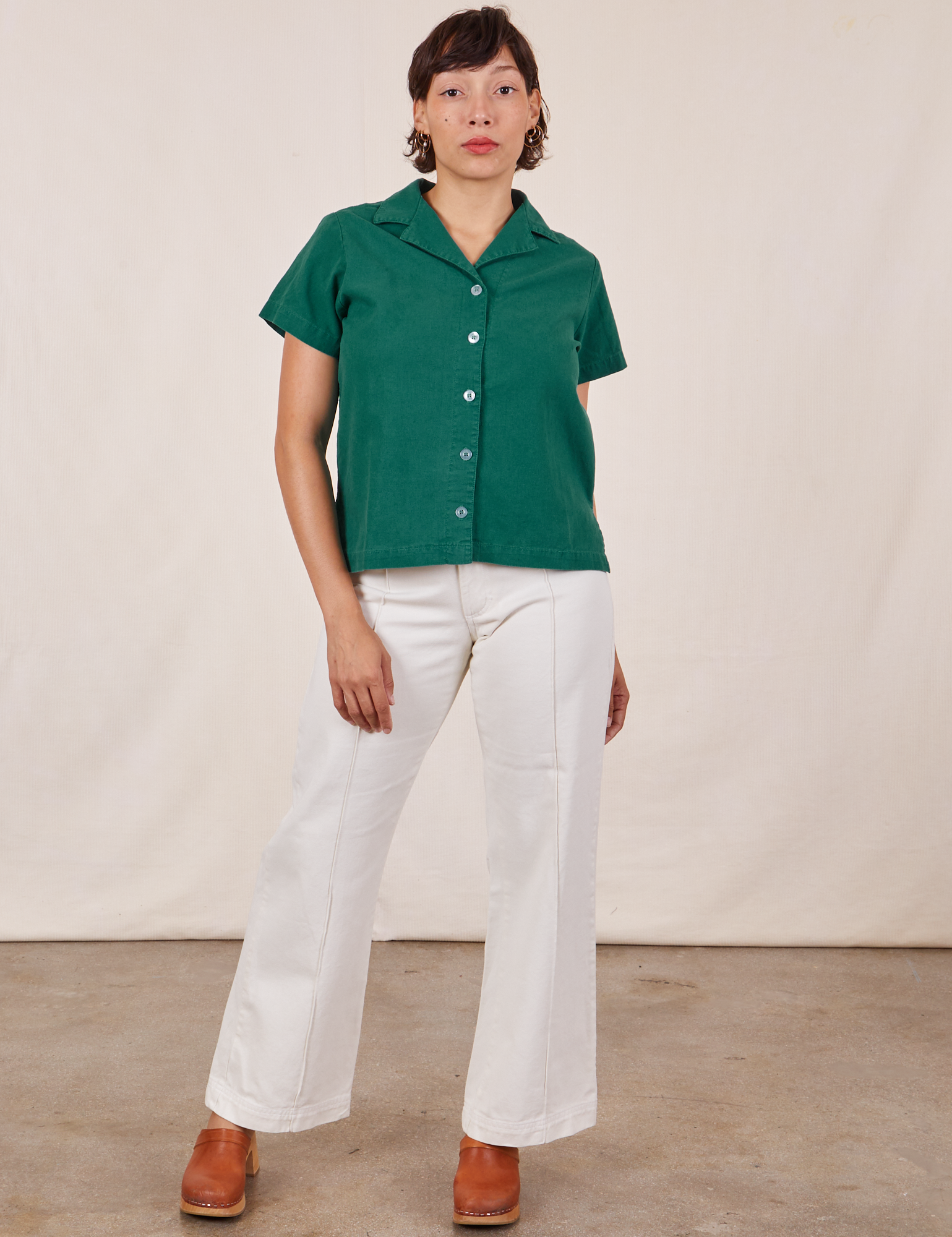 Tiara is wearing size XS Pantry Button-Up in Hunter Green paired with vintage off-white Western Pants