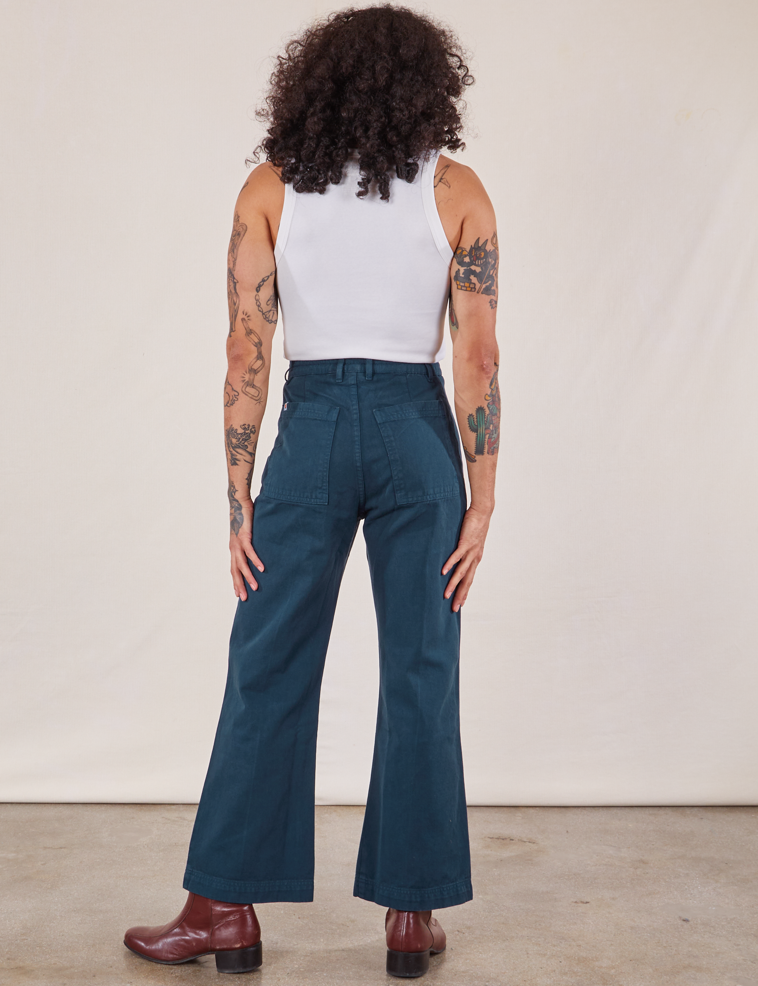 Jesse is wearing Western Pants in Lagoon and vintage tee off-white Cropped Tank
