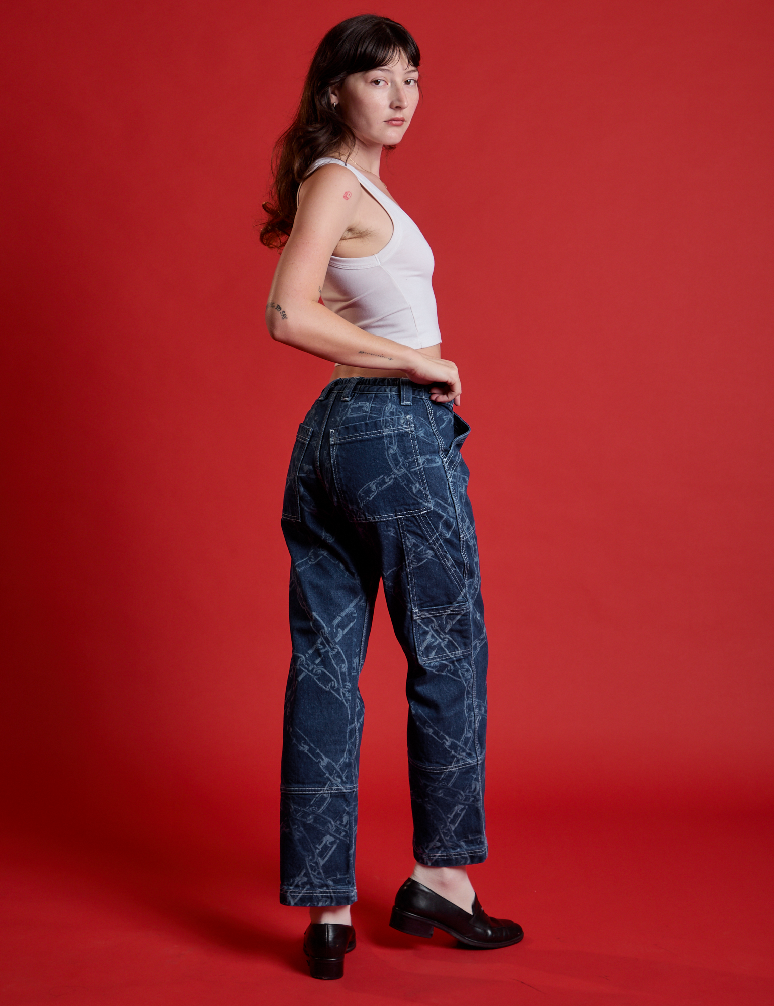 Angled back view of Mid-Rise Carpenter Jeans in Chain Link on Alex