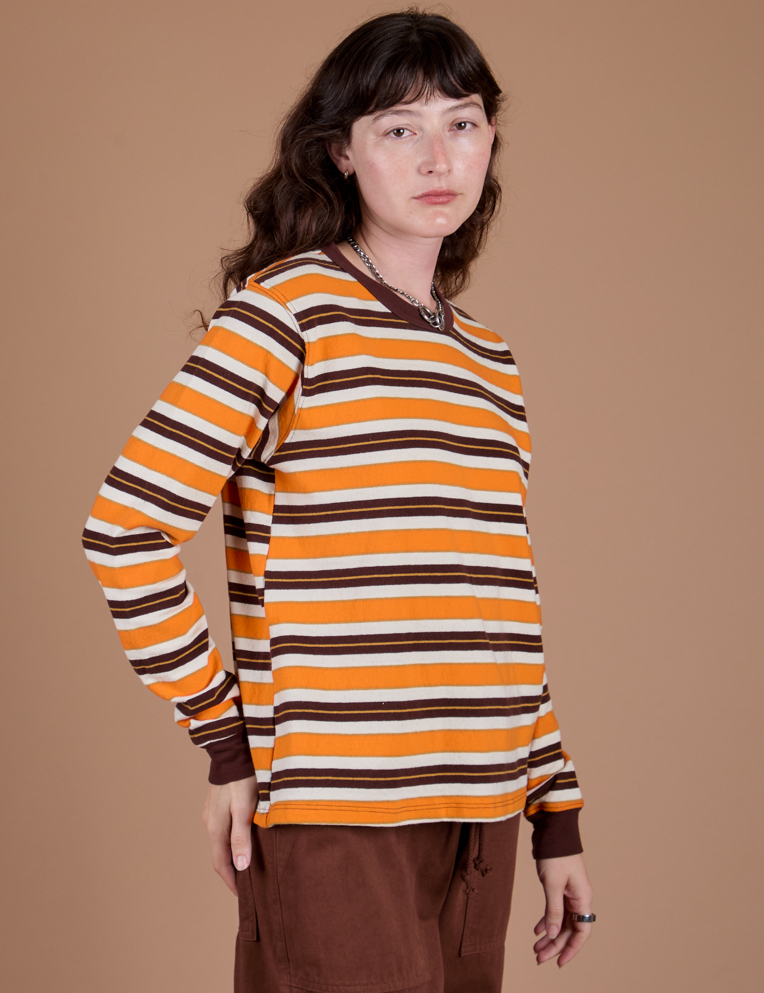 Angled front view of Long Sleeve Striped Burly Tee in Orange on Alex