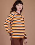 Angled front view of Long Sleeve Striped Burly Tee in Orange on Alex