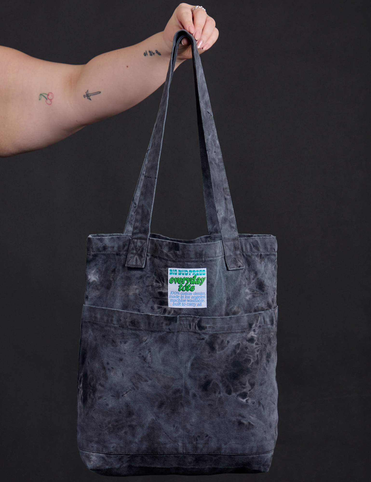 Everyday Tote in Black Magic Waters held by model