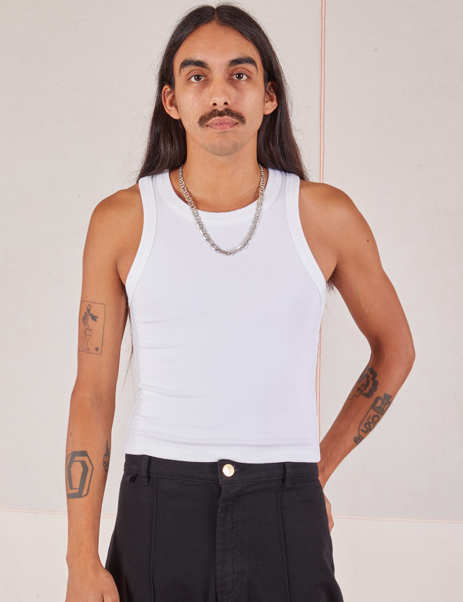 Anthony is 5’10” and wearing S Racerback Tank in Vintage Tee Off-White