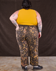Back view of Marble Splatter Work Pants in Espresso Brown and mustard yellow Tank Top on Sam