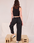 Back view of Mid-Rise Pleated Trousers in Basic Black and black Cropped Tank on Alex