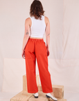 Back view of Mid-Rise Pleated Trousers in Chili Red and Cropped Tank in vintage tee off-white worn by Alex