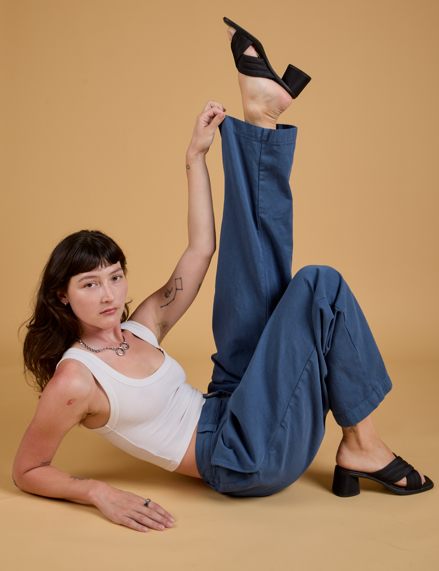 Alex is wearing Baggy Mid-Rise Trousers in French Blue and vintage tee white Cropped Tank