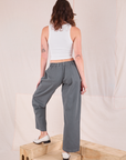 Back view of Mid-Rise Pleated Trousers in Slate Grey and Cropped Tank in vintage tee off-white on Alex