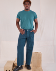 Issac is 5'10" and wearing M Mid-Rise Work Pants in Lagoon paired with marine blue Organic Vintage Tee