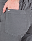 Mid-Rise Work Pants in Slate Grey close up of Margaret's hand in the back pocket