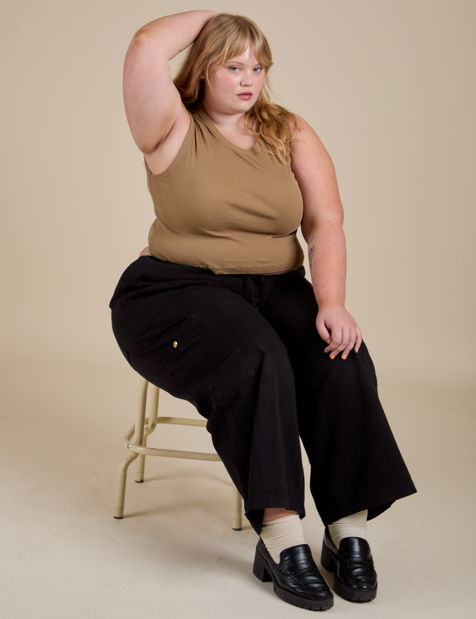 Juliet is wearing Muscle Tee in Desert Brown and black Drop Pocket Cargo Pants