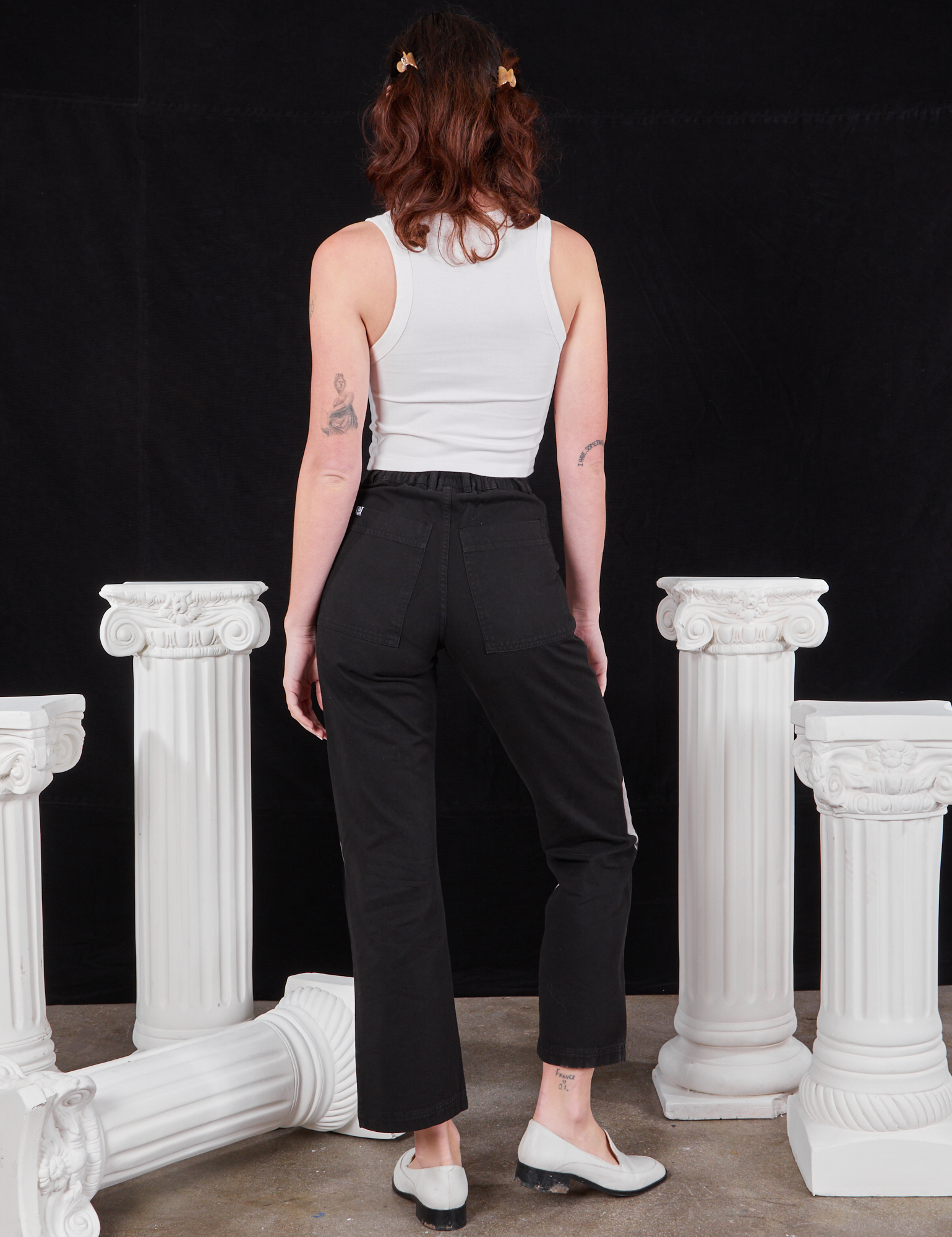 Back view of Black Venus Work Pants and vintage off-white Cropped Tank Top on Alex