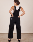 Back view of Original Overalls in Mono Black worn by Tiara. She has both hands in the back pockets.