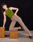 Alex is wearing Work Pants in Autumn Stripe and summer olive Racerback Tank