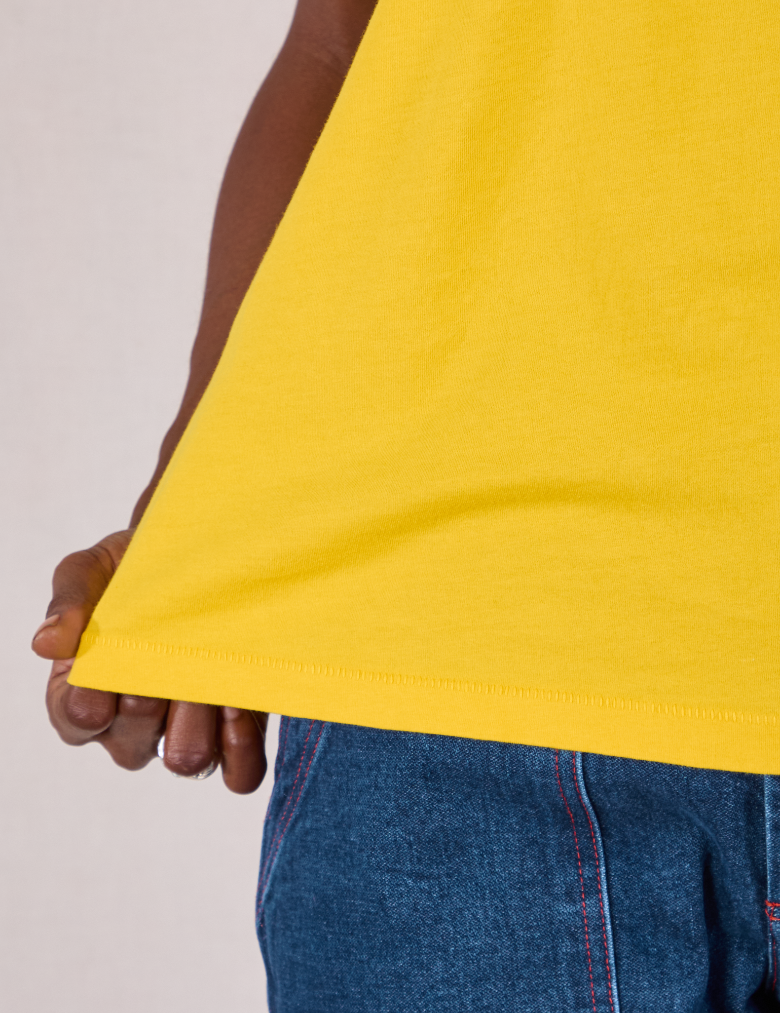 Organic Vintage Tee in Golden Yellow bottom hem close up on Cheyann