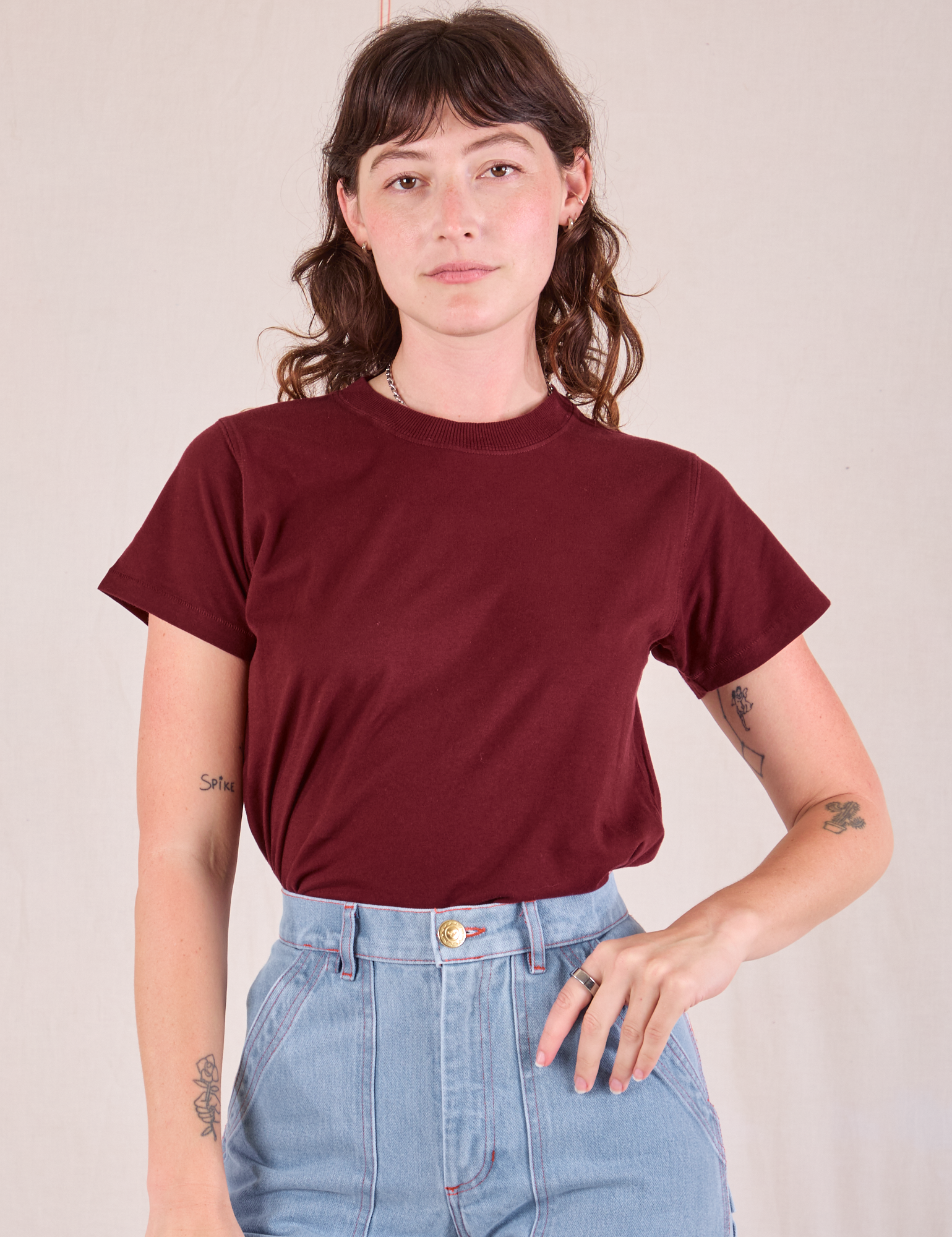 Alex is wearing Organic Vintage Tee in Red Wine tucked into her light wash Carpenter Jeans