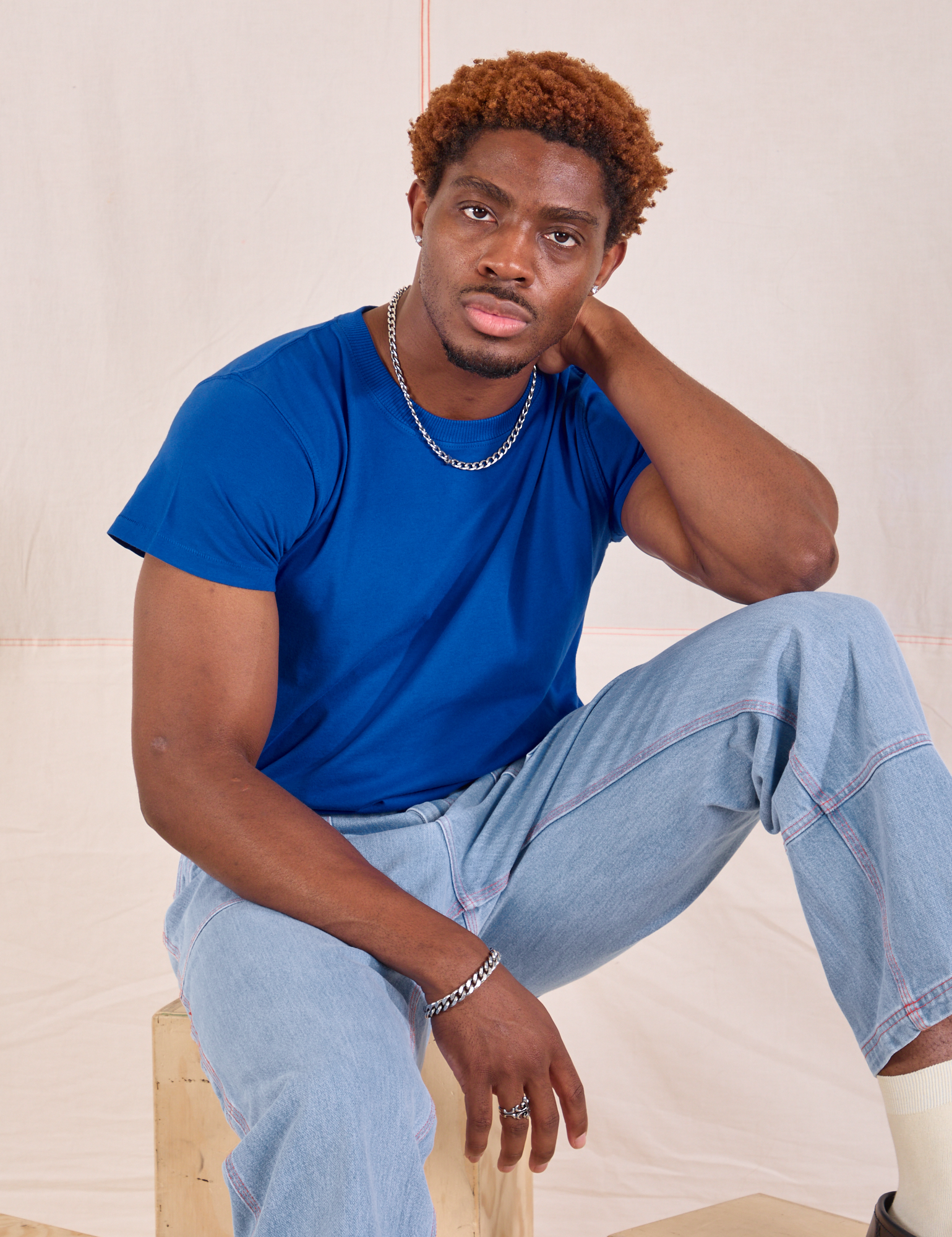 Issac is wearing Organic Vintage Tee in Royal Blue and light wash Carpenter Jeans