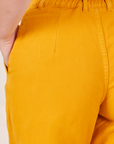 Back close up of Organic Trousers in Mustard Yellow worn by Alex