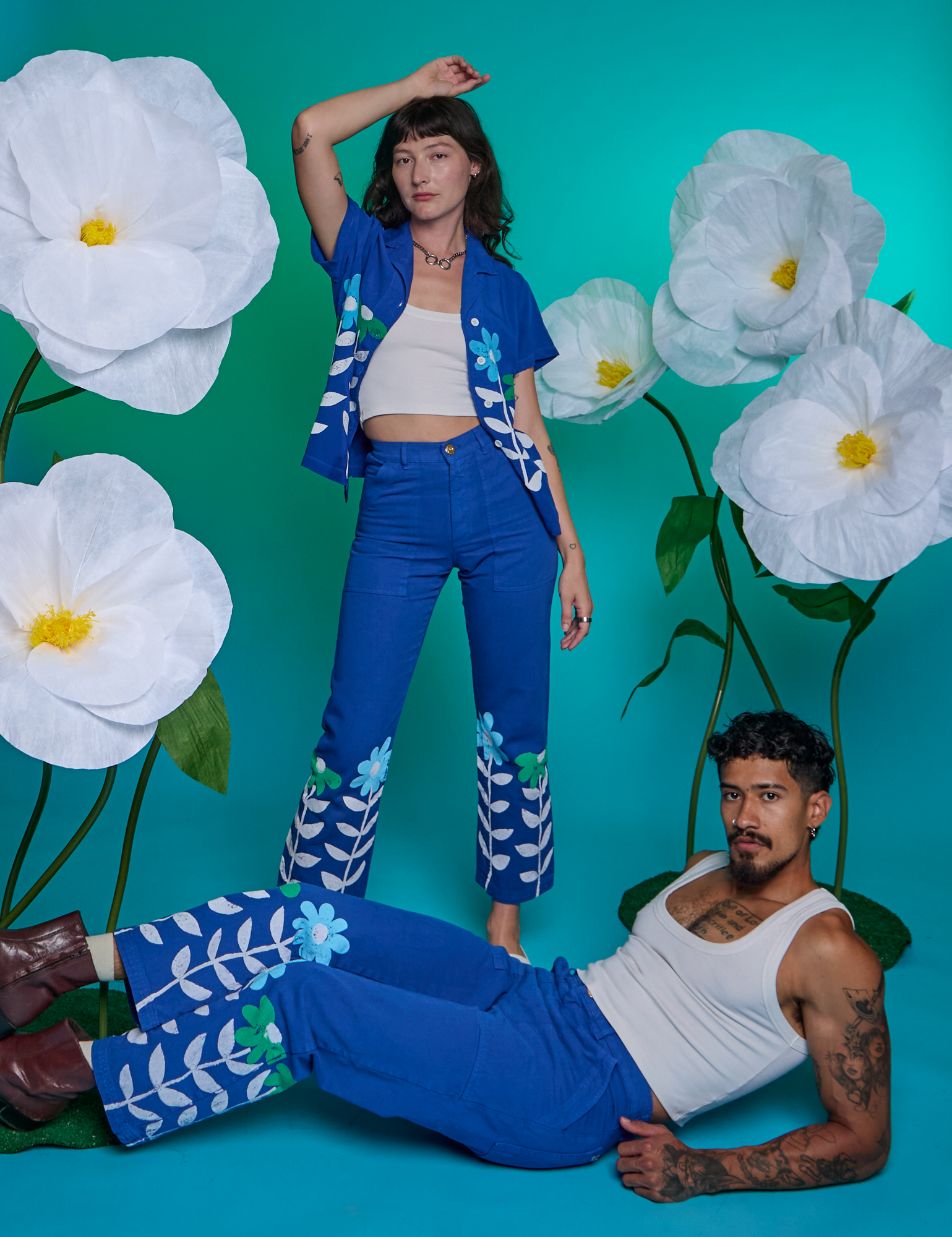 Jesse is wearing Paintstamped Work Pants in Daisy. Alex is wearing Paintstamped Work Pants in Daisy with matching Pantry Button-Up