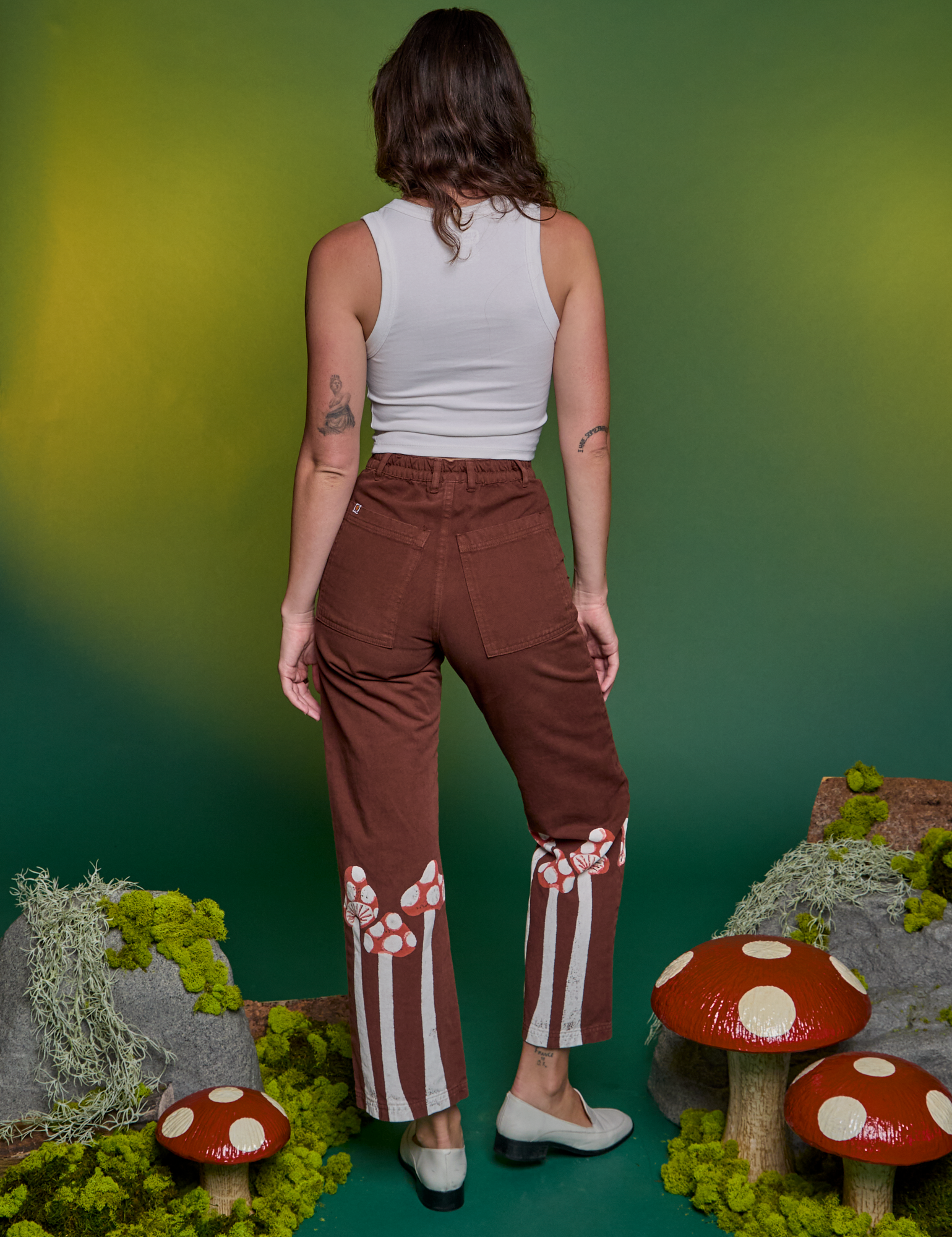 Back view of Paintstamped Work Pants in Mushroom and Cropped Tank in Vintage Tee White on Alex