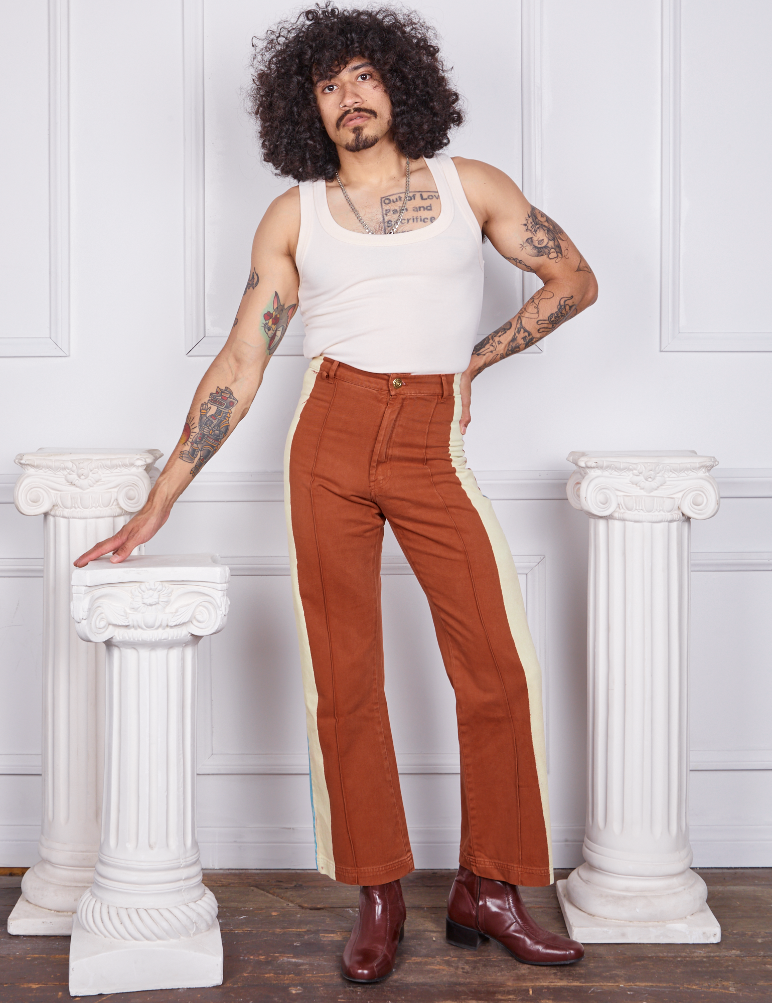 Jesse is 5&#39;8&quot; and wearing XS Hand-Painted Stripe Western Pants in Burnt Terracotta paired with a vintage off-white Tank Top