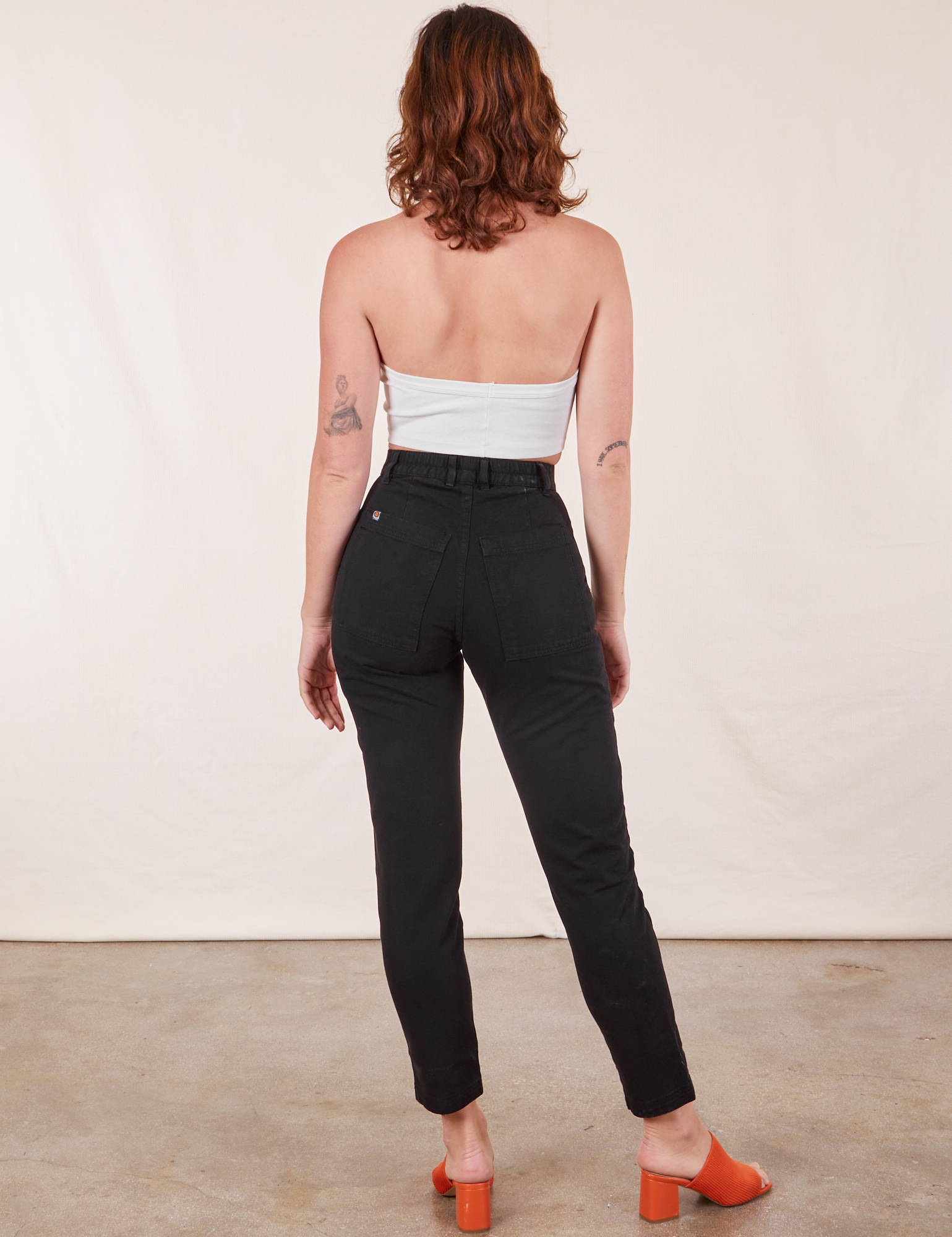 Back view of Pencil Pants in Basic Black and vintage off-white Halter Top on Alex