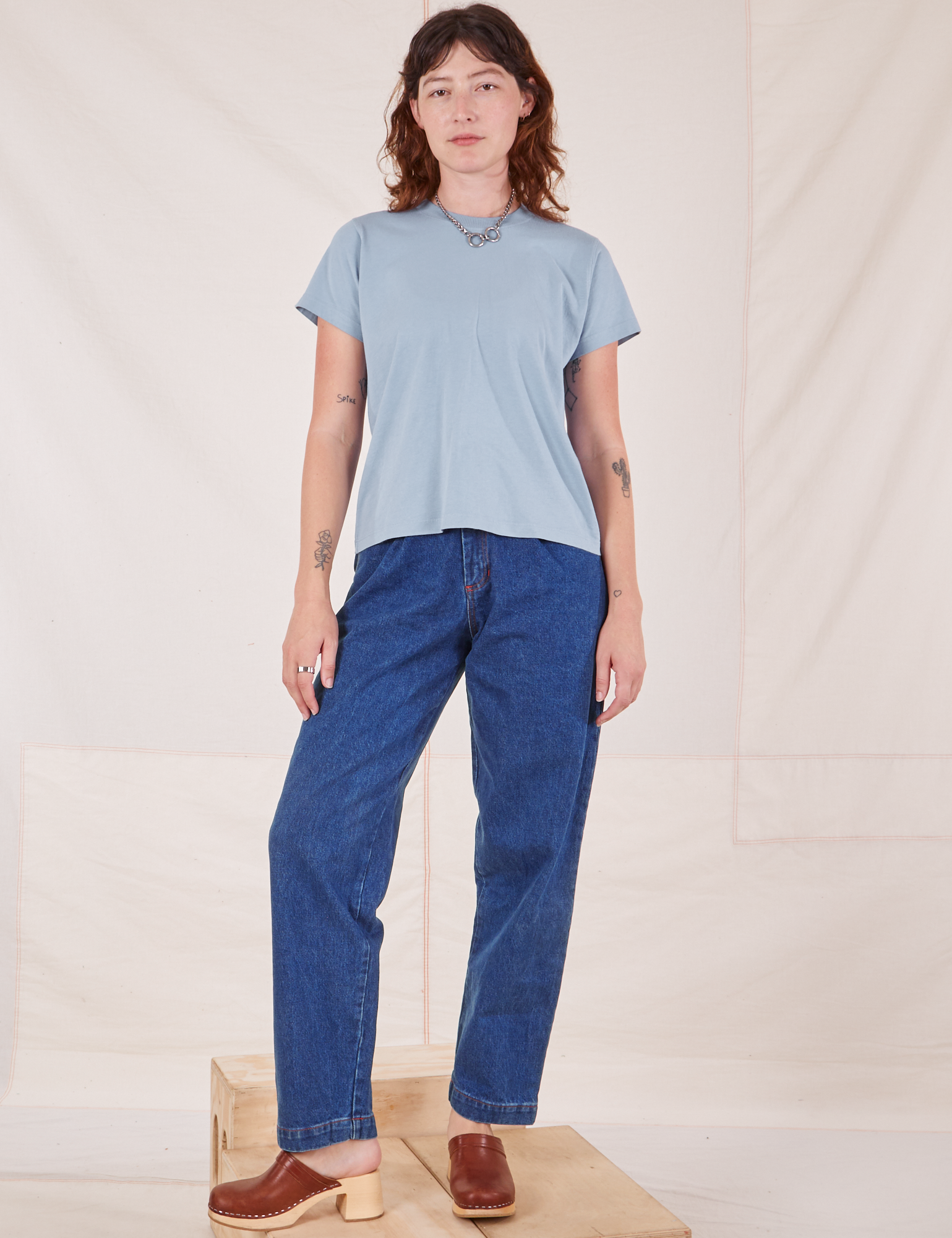 Alex is 5&#39;8&quot; and wearing P The Organic Vintage Tee in Periwinkle paired with dark wash Denim Trouser Jeans