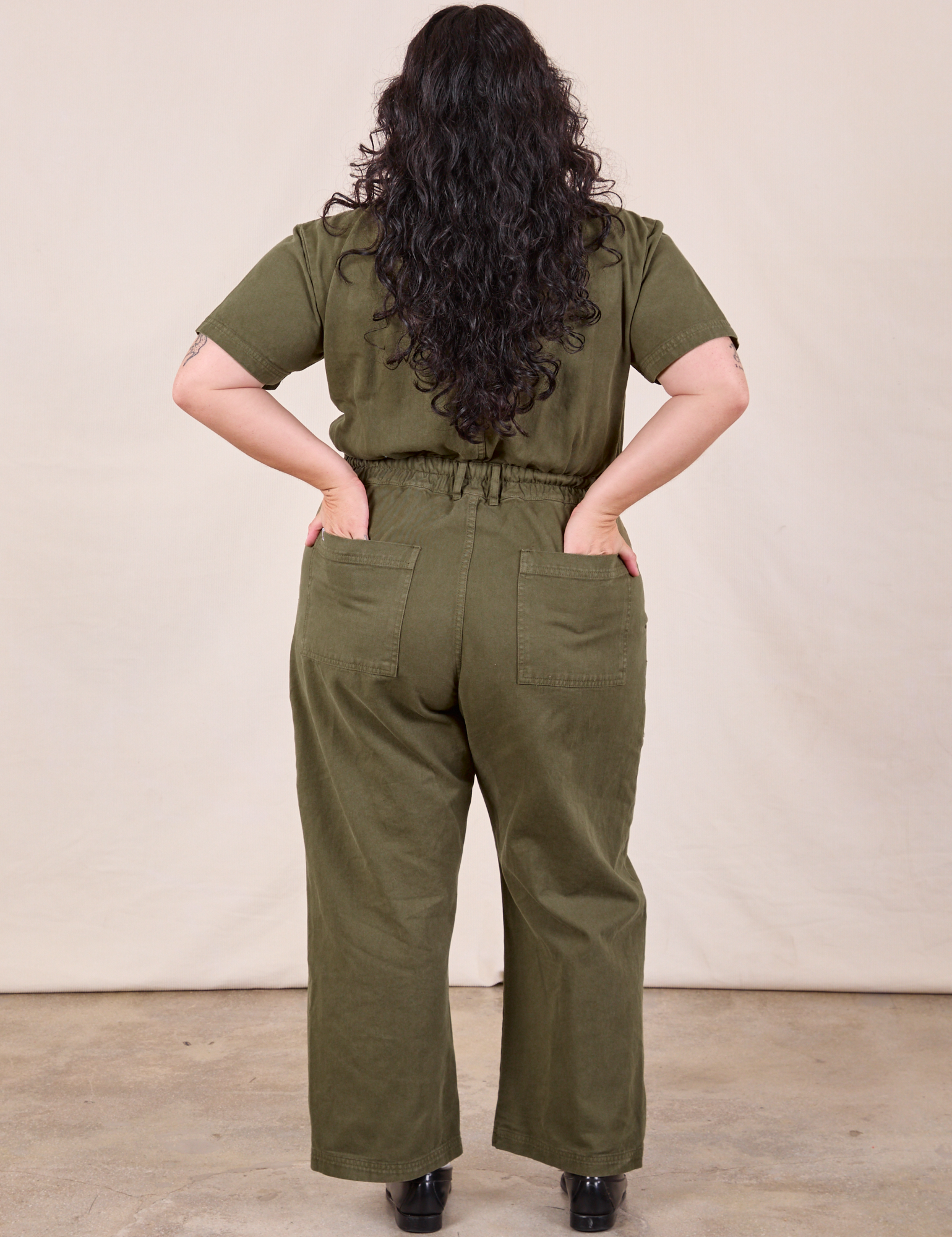 Petite Short Sleeve Jumpsuit in Surplus Green back view on Ari