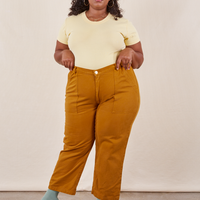 Morgan is 5'5" and wearing Petite 1XL Work Pants in Spicy Mustard paired with butter yellow Baby Tee