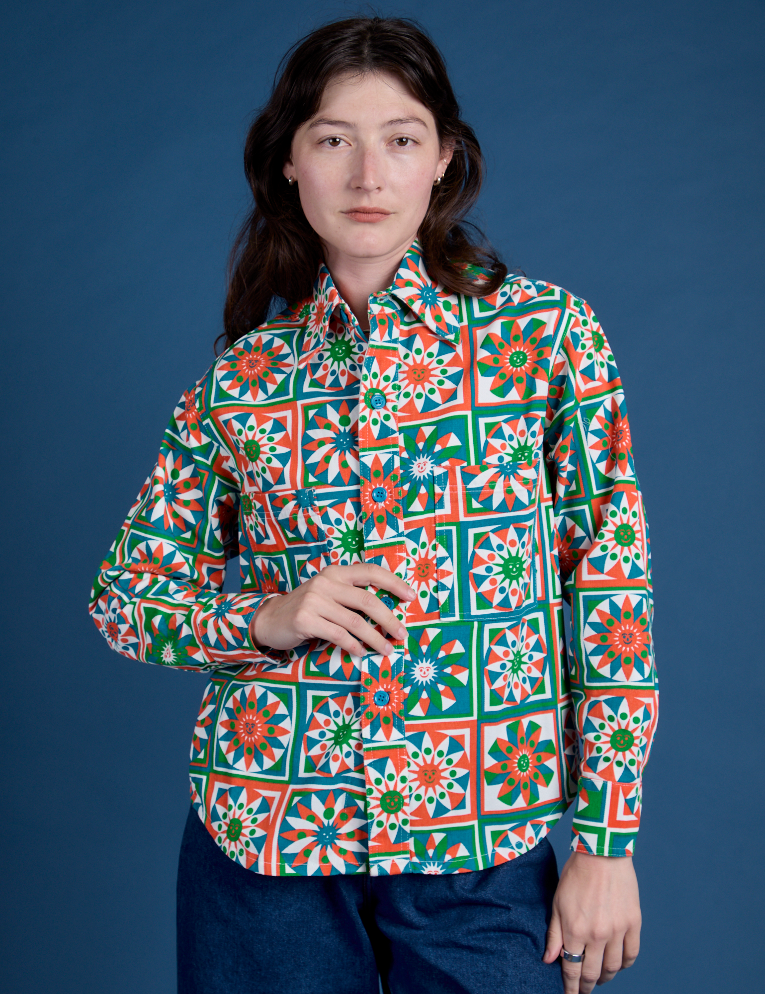 Alex is wearing a buttoned up Cropped Overshirt in Quilt Print