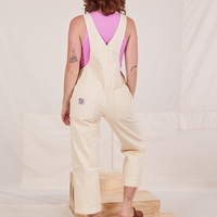 Back view of Rainbow Overalls and bubblegum pink Cropped Tank Top underneath worn by Alex