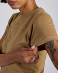 Close up of Jr. Varsity Tee in Desert Brown sleeve on Kira
